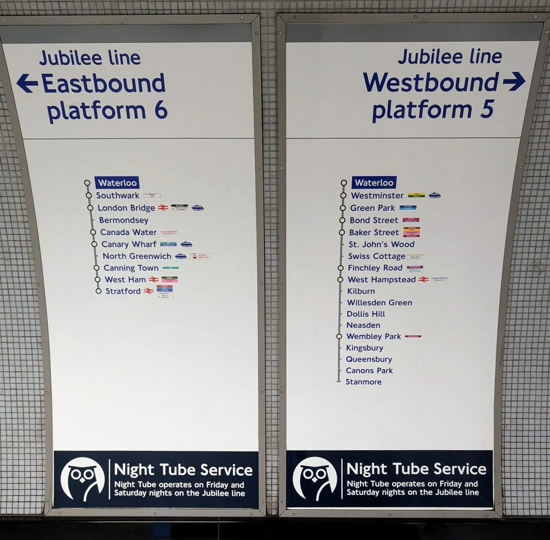 Two Jubilee line direction signs at Waterloo, one reading Eastbound platform 6 and one Westbound platform 5, each listing every station in that direction, with a Night Tube panel below