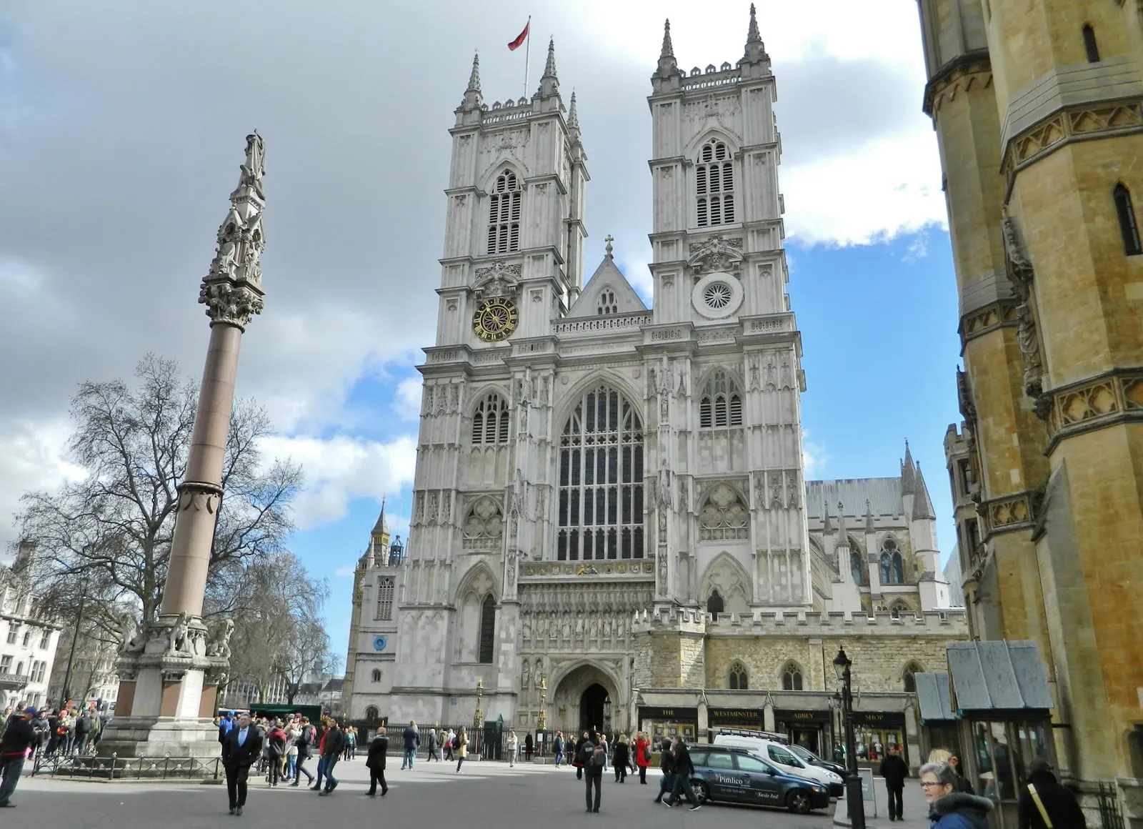 The twin Gothic towers and Great West Door of Westminster Abbey viewed from the Broad Sanctuary under a blue sky