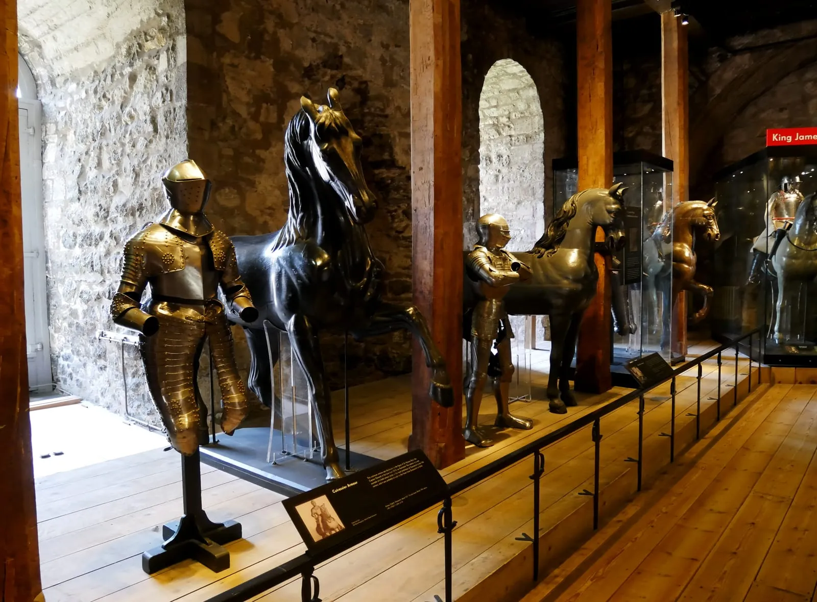 A display of mounted horse armour and royal suits of plate from the Line of Kings inside the White Tower