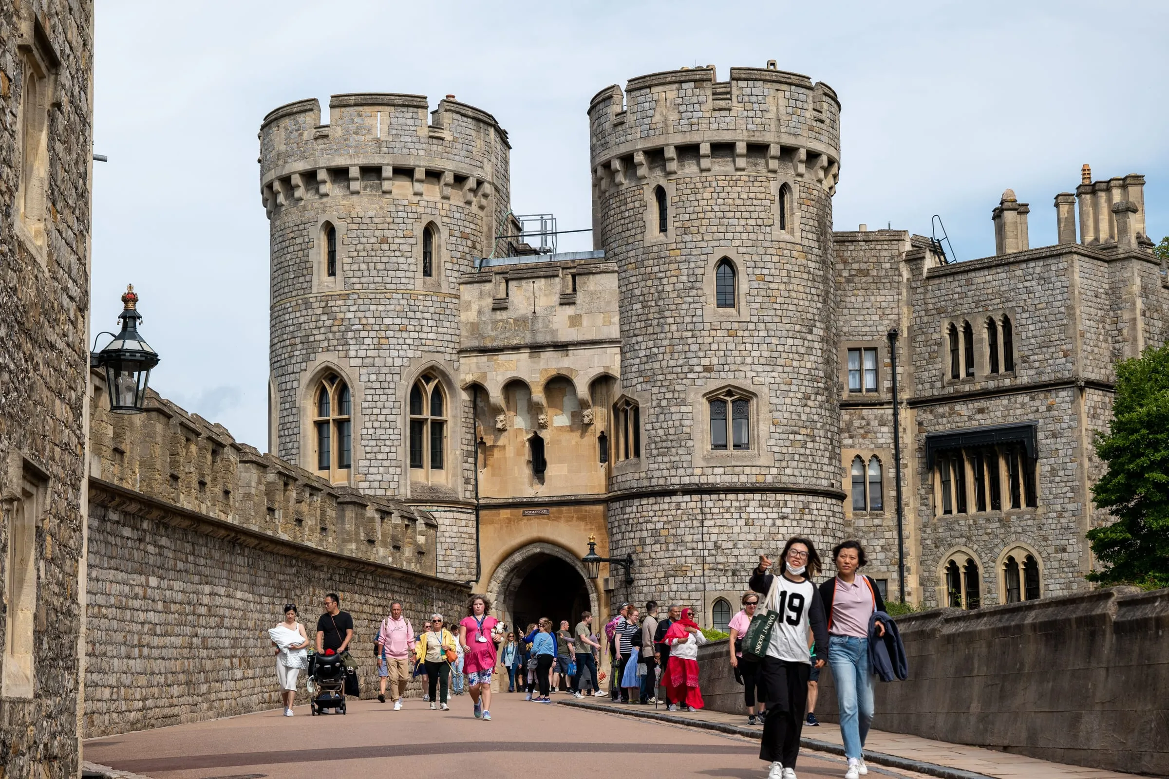 Visitors walking up to Windsor Castle's gatehouse, its two round towers rising above the crowd