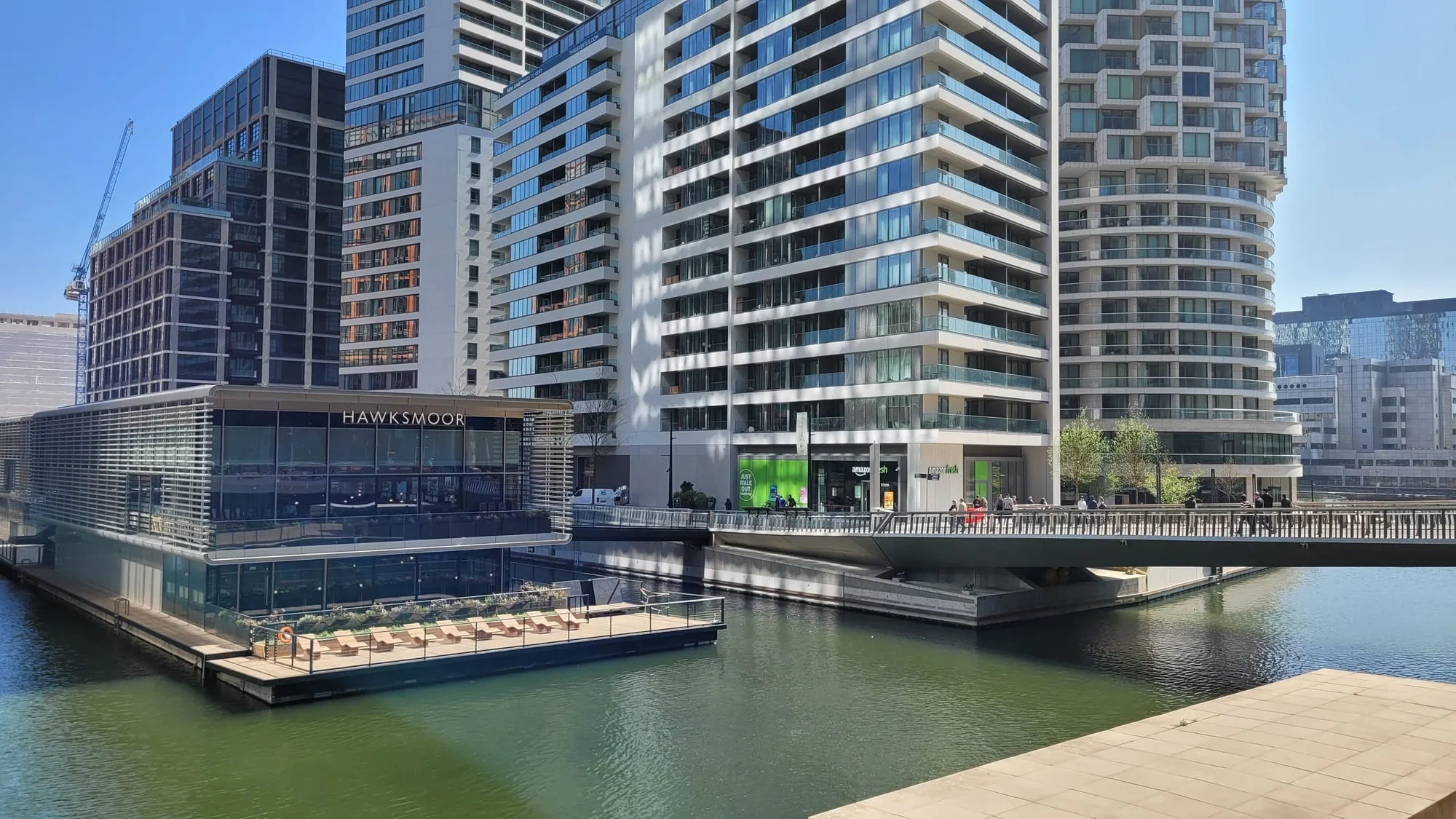 Glass-fronted restaurants including a floating Hawksmoor along the Wood Wharf waterside promenade